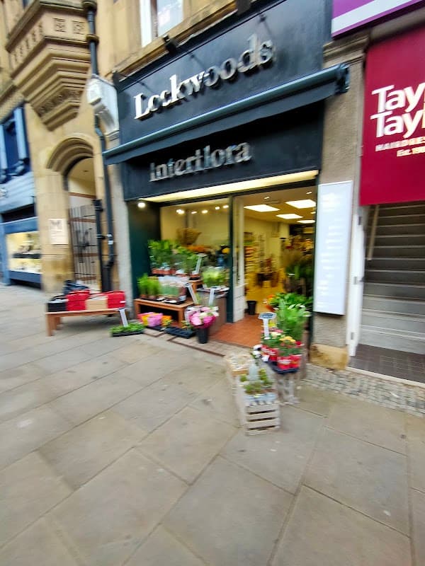 Lockwoods Interflora storefront with flower displays, located in a stone building on a city street in Sheffield.
