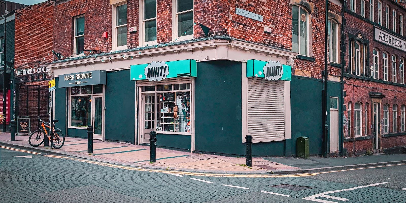 Jewelry shop "Mint" in Sheffield, featuring a bright turquoise sign, large windows, and a brick facade.
