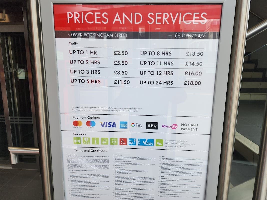 Prices and services sign for ParkBee Q-Park in Sheffield, detailing parking tariffs and payment options.