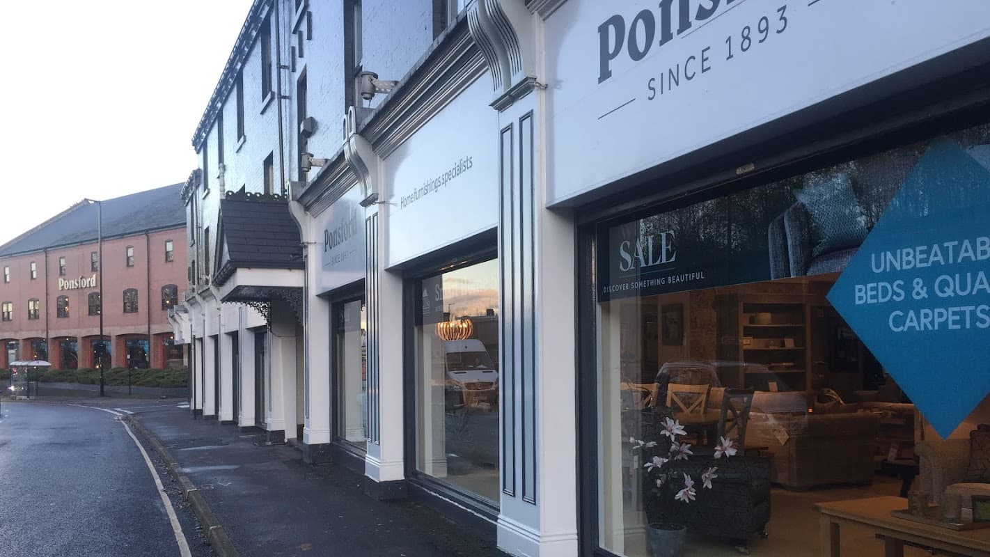 Ponsford homeware store with large windows displaying furniture and sale signage, set on a quiet street in Sheffield.