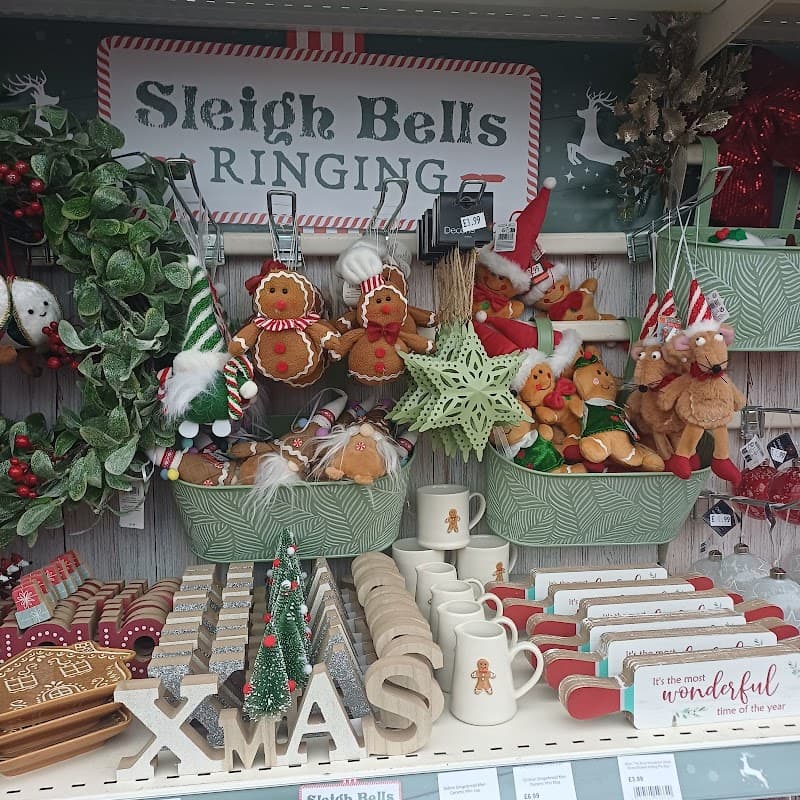 Festive decorations and gifts, including gingerbread figures, wreaths, and Christmas-themed items on display.