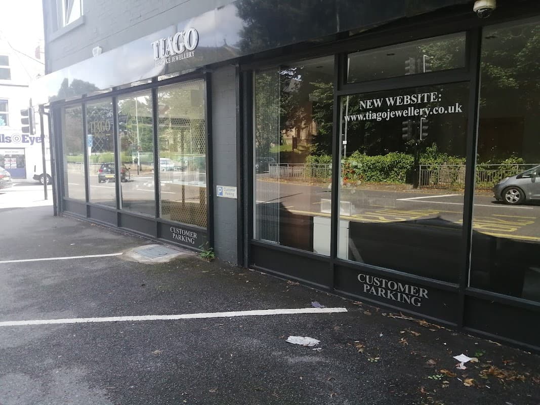 Tiago Jewellery storefront with large windows, showcasing signage for a new website and customer parking.