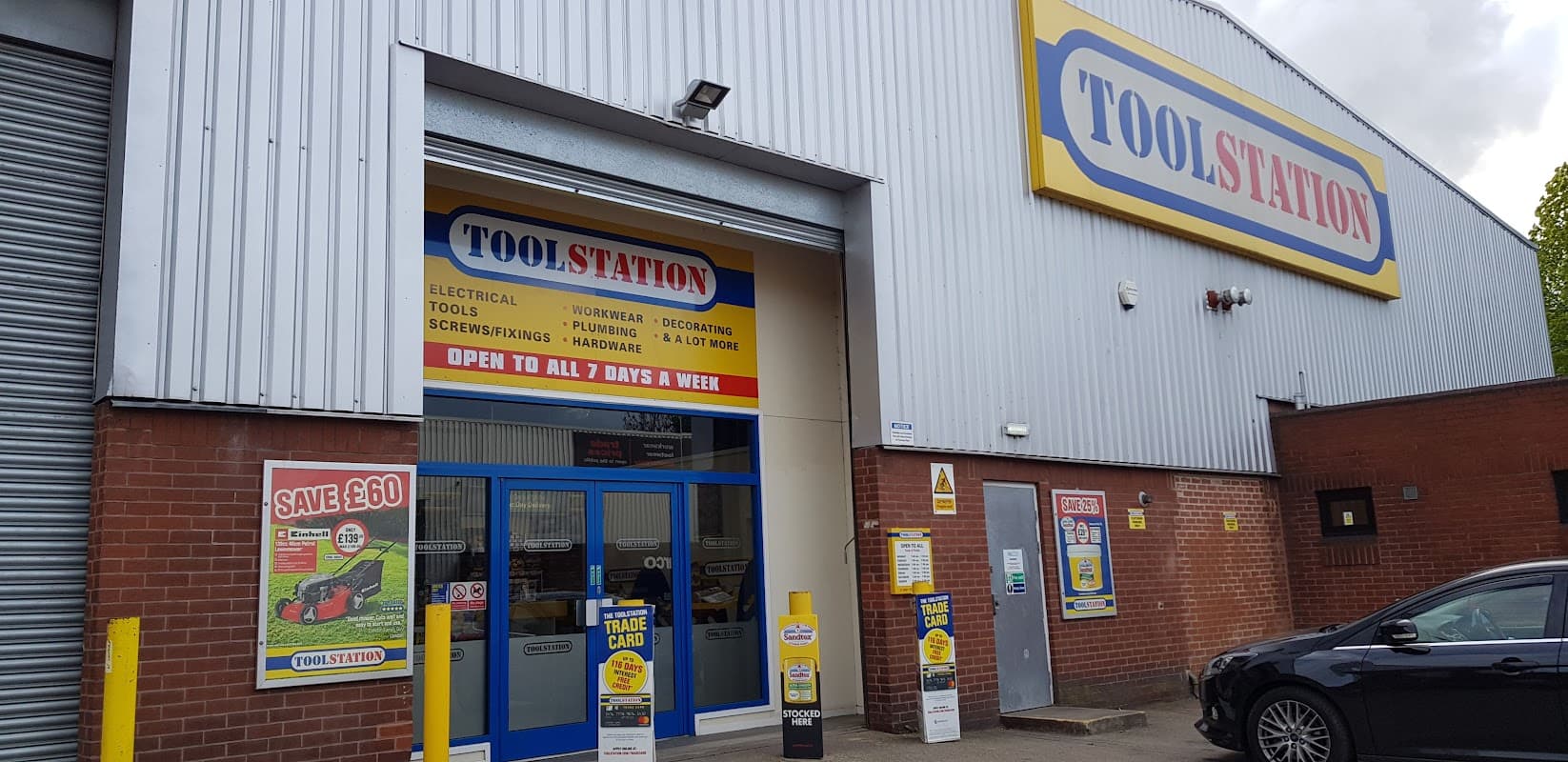 Brightly colored storefront of Toolstation in Sheffield, featuring signage for tools and homeware, with a car parked outside.