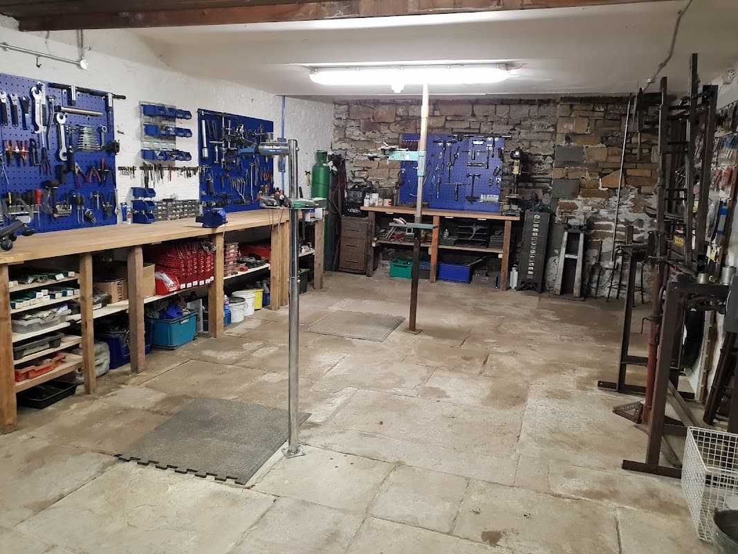 Bike workshop with tool storage, workbenches, and a clean, organized floor in Sheffield, Yorkshire.