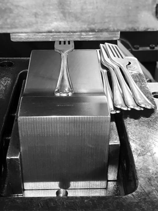 Welcome to Inkerman Silver, showcasing Sheffield cutlery manufacturing with forks placed on a metal block.