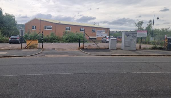 Pay & Display parking lot in Sheffield, with a building in the background and a few parked cars visible.