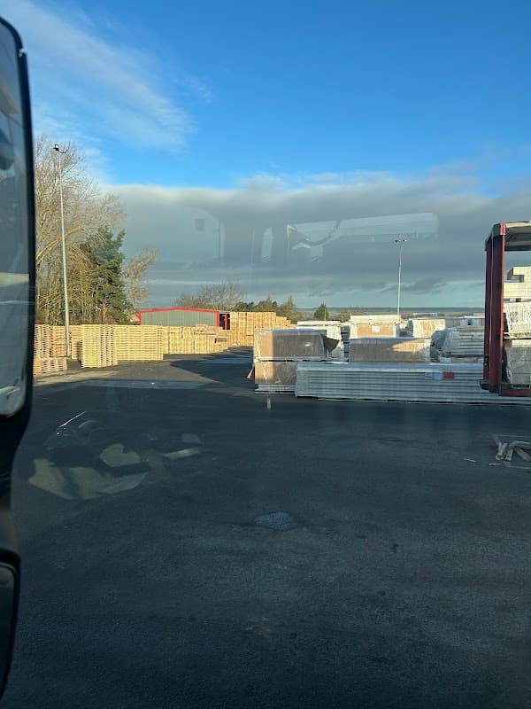 Warehouse with stacked insulated panels under a clear blue sky in Sherburn, Yorkshire.