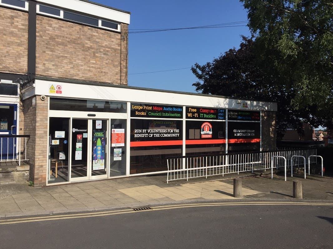 Sherburn & Villages Community Library entrance with large windows displaying community information and colorful signage.