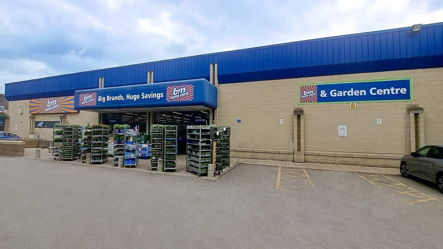 B&M Home Store entrance with garden centre, featuring signage and plant displays, located in Skipton, Yorkshire.