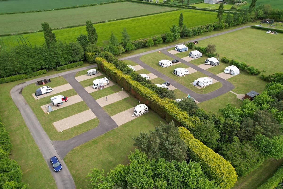 Aerial view of Robin Hood Caravan Park featuring neatly arranged caravans and green fields in Slingsby, Yorkshire.