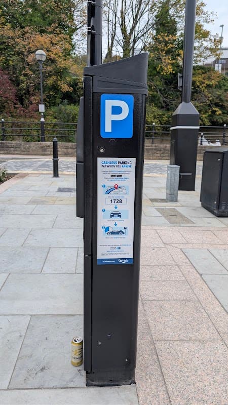 Pay & Display parking machine at 50 Tuel Ln, Sowerby Bridge, with instructions and a nearby can on the ground.