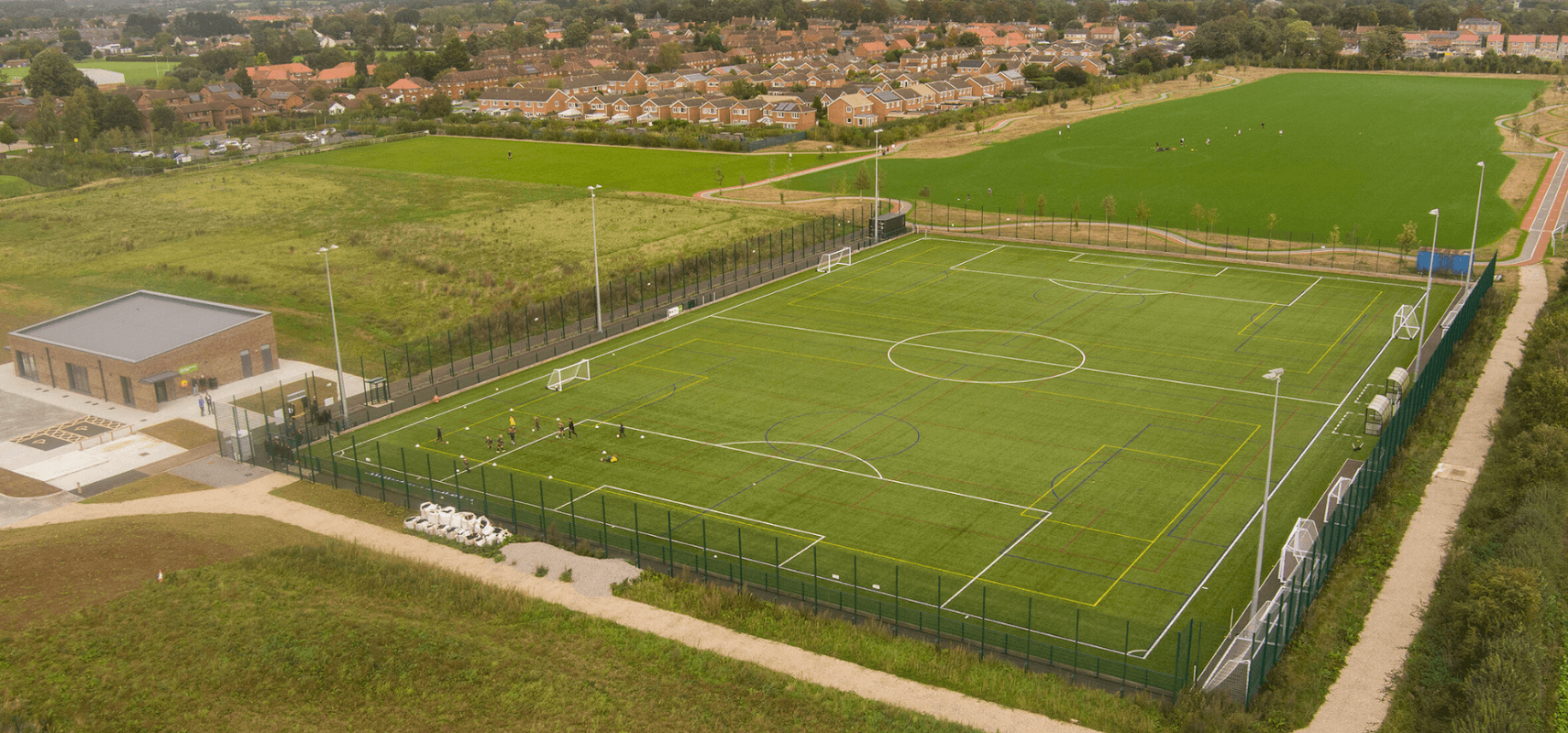 Aerial view of Thirsk Falcons FC's football pitch, surrounded by green fields and residential areas.