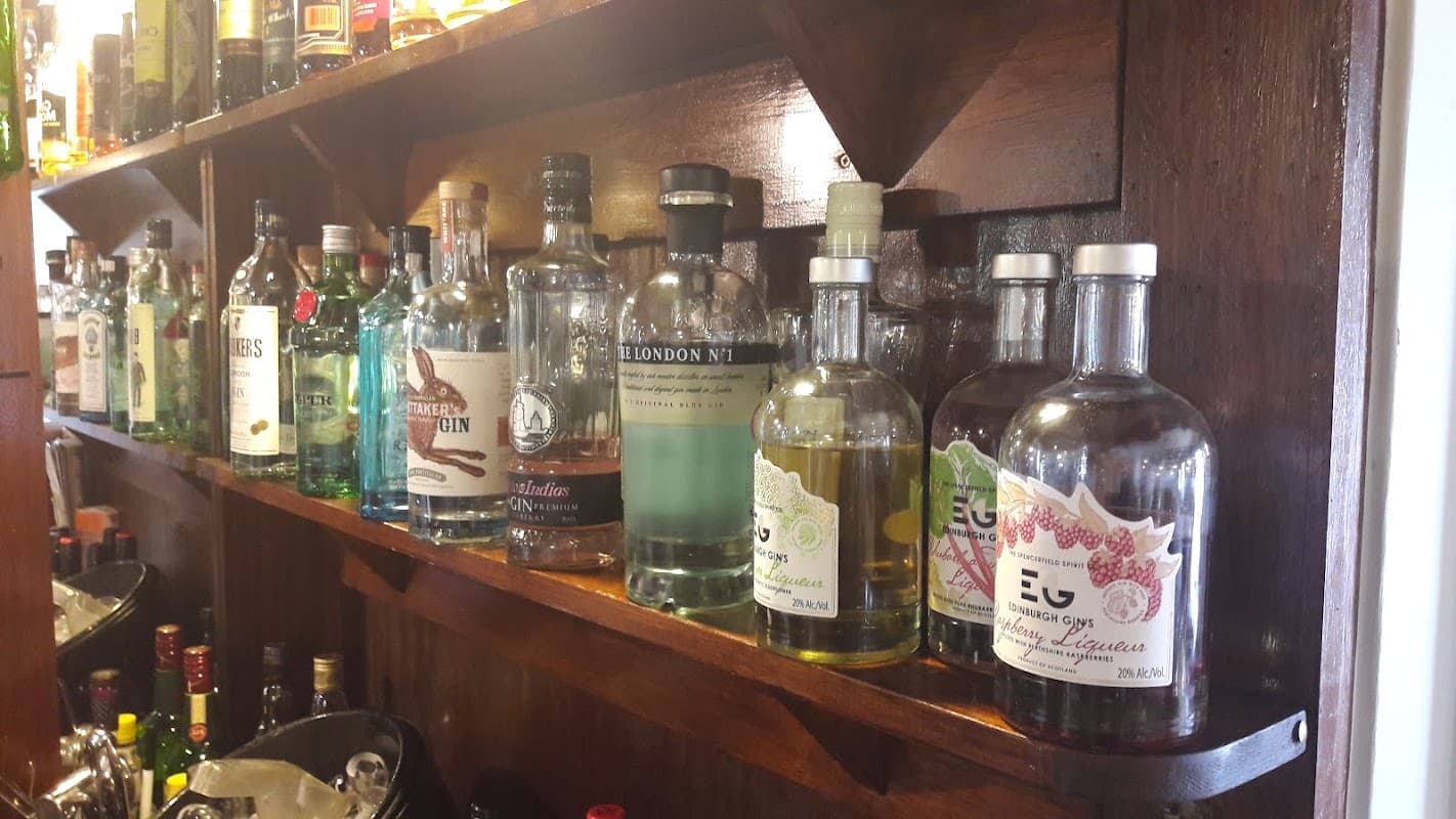 Shelves filled with various bottles of gin and spirits at The White Bear Inn bar in Stillington, Yorkshire.