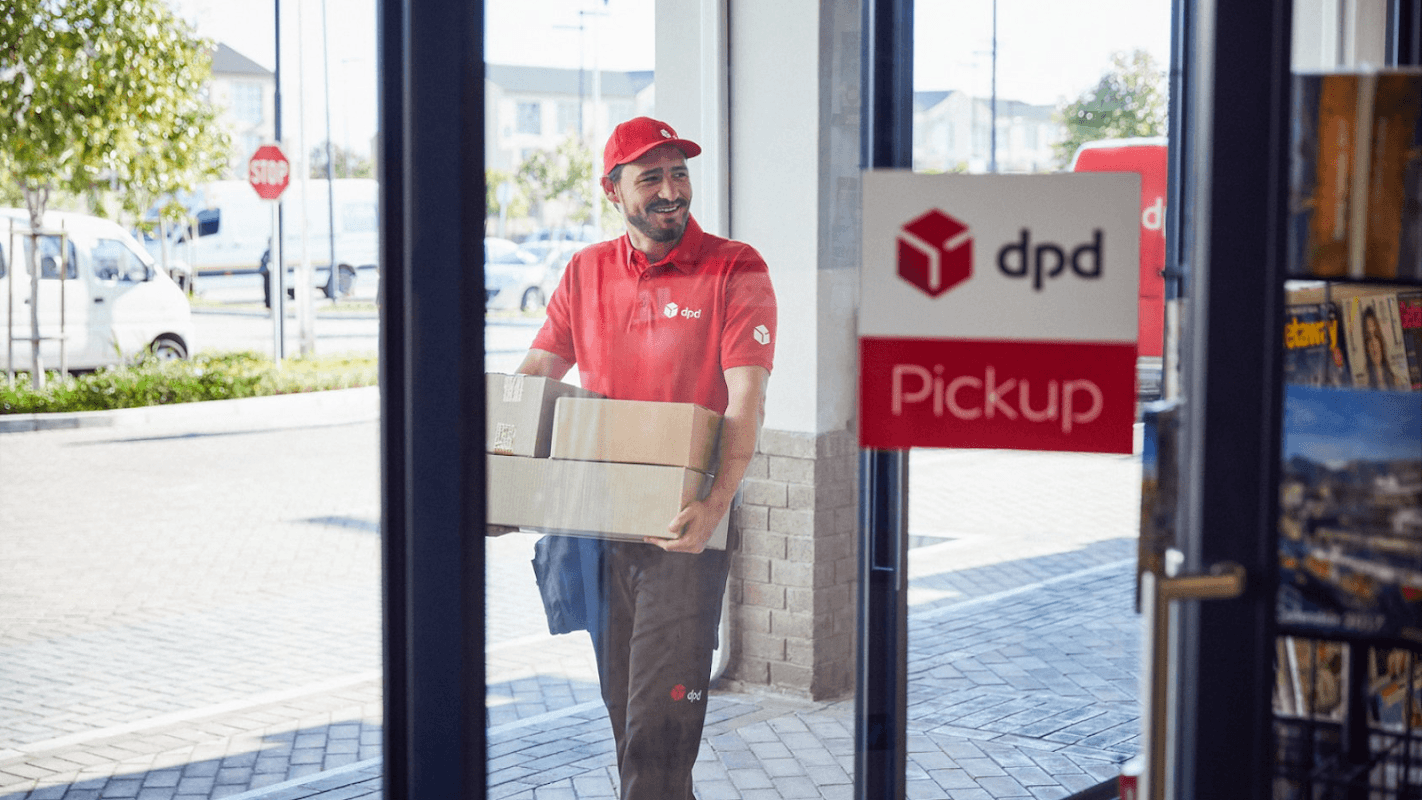 A delivery person in red uniform carries a package through a glass door with a DPD Pickup sign.
