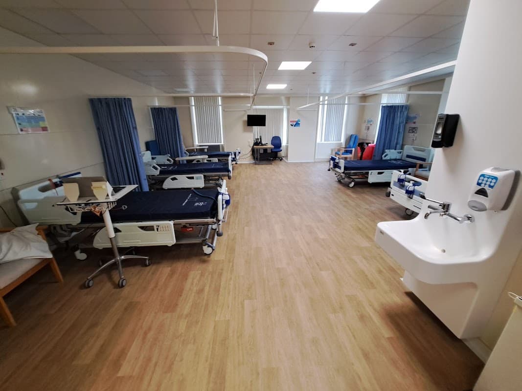 Furniture shop interior with display setups, showcasing various furniture pieces in a well-lit space.