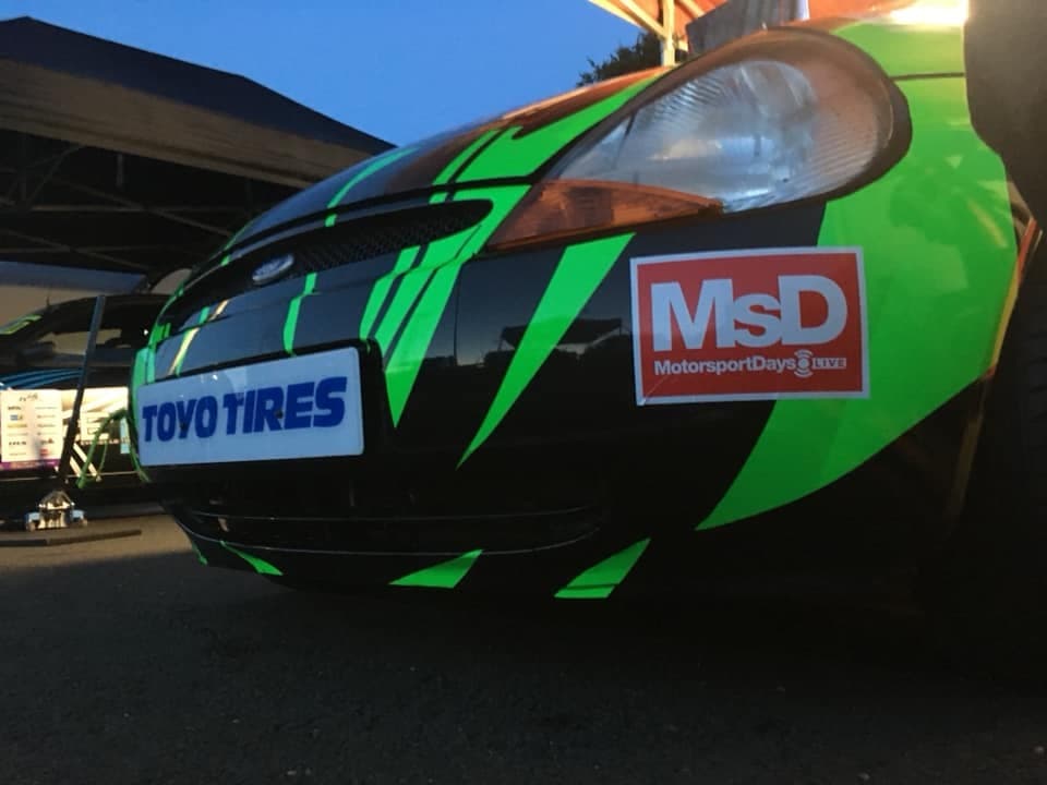 Green and black striped car with Toyo Tires and MotorsportDays logos, parked at Shine Automotive Thirsk.