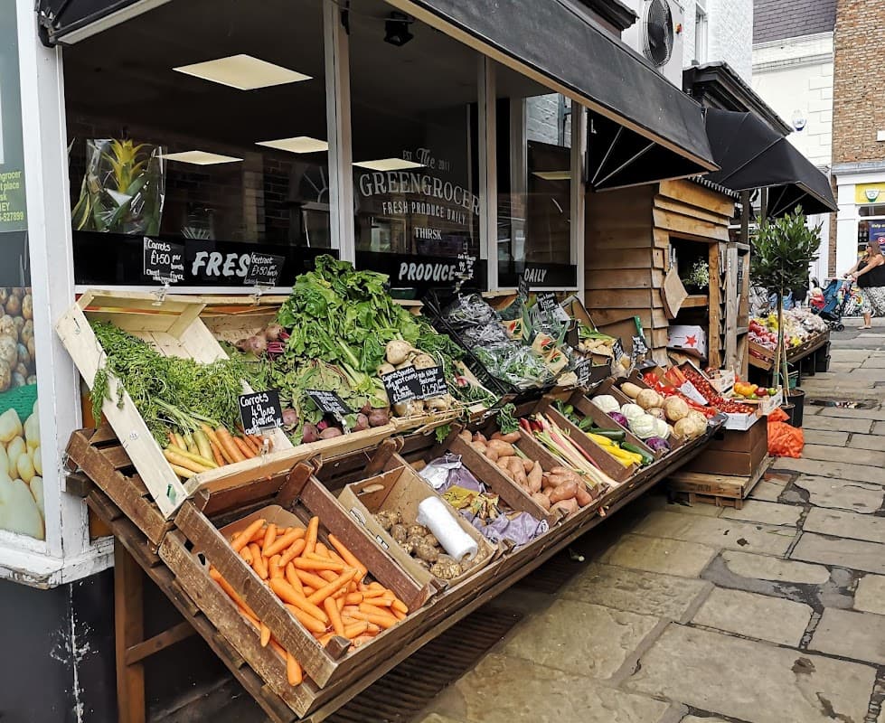 Colorful display of fresh vegetables and produce outside The Greengrocer shop in Thirsk, Yorkshire.
