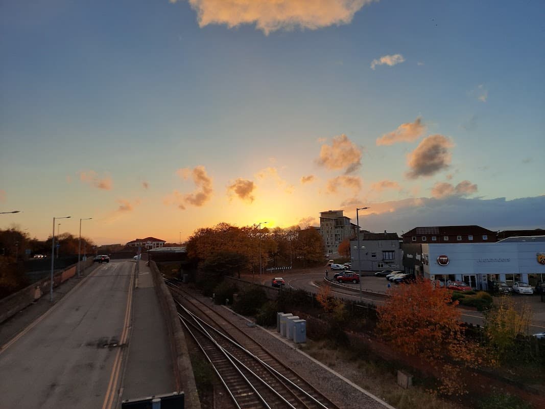Sunset over a car park with autumn trees, buildings, and railway tracks in Thornaby, Yorkshire.