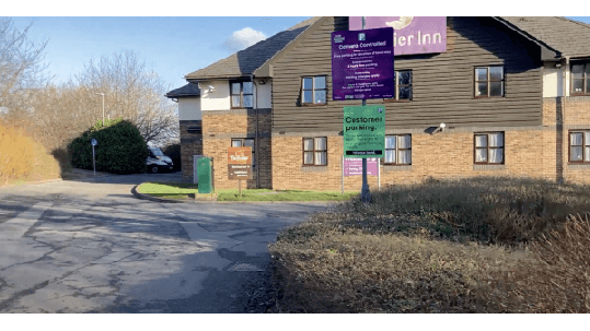 Car park entrance near a Premier Inn, with signage for customer parking and a tree-lined area in Thornaby, Yorkshire.