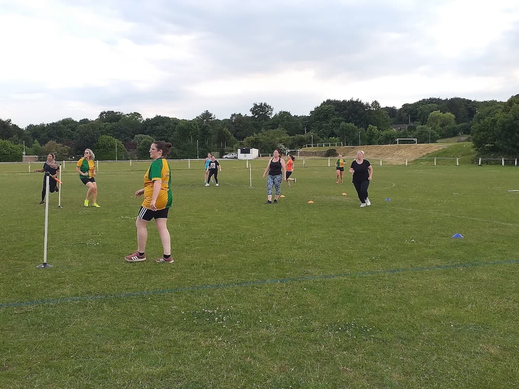 Participants engaged in a cricket practice session on a grassy field at Thornhill Cricket & Bowling Club.