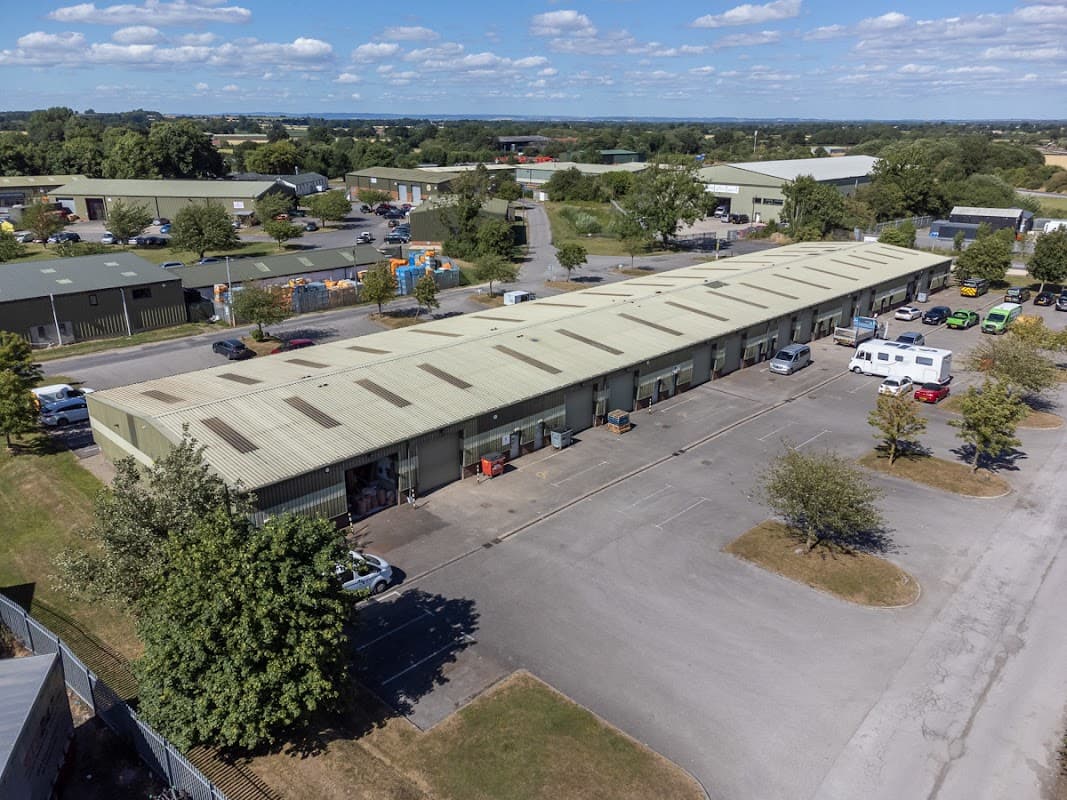 Aerial view of Flexspace Tockwith, featuring multiple industrial units, parking spaces, and surrounding greenery.
