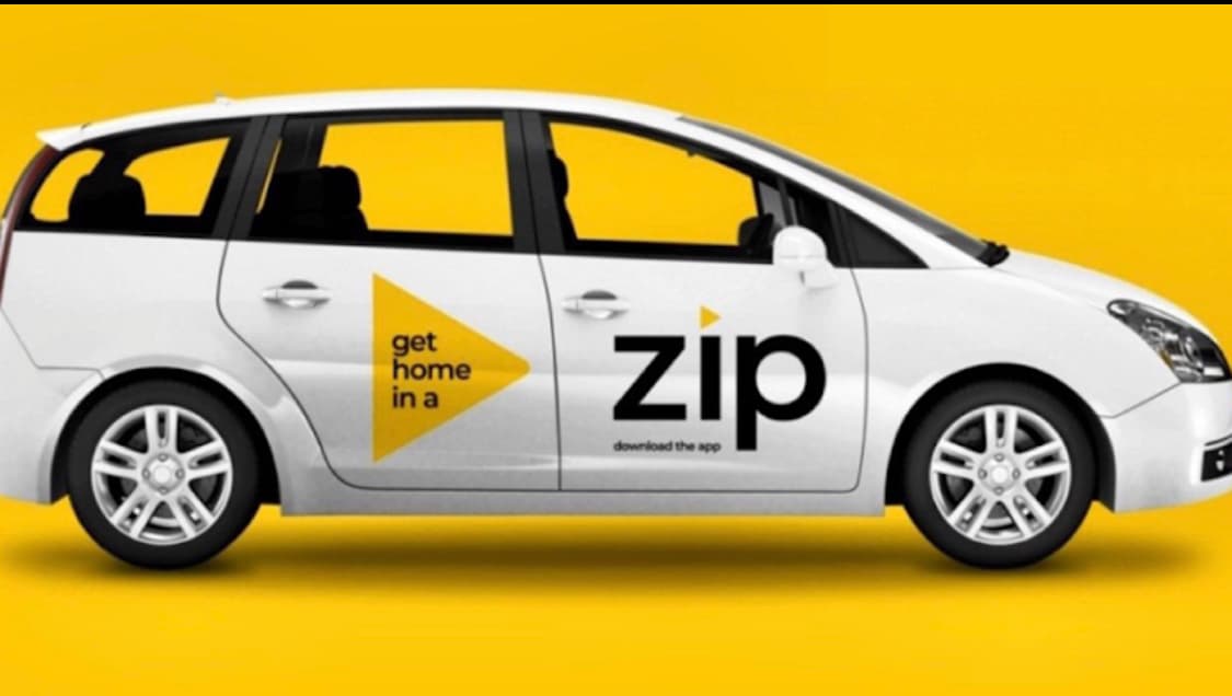 White taxi with "get home in a zip" slogan and logo on a bright yellow background.