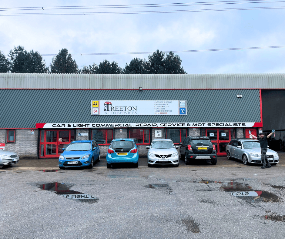 Treeton Auto Services shopfront with parked cars, signage for repair and MOT services, and a cloudy sky above.