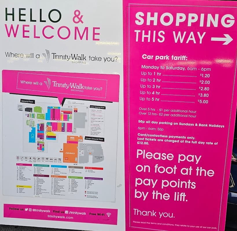 Signage for Trinity Walk Car Park with parking rates, hours, and a map of the shopping area in Wakefield, Yorkshire.