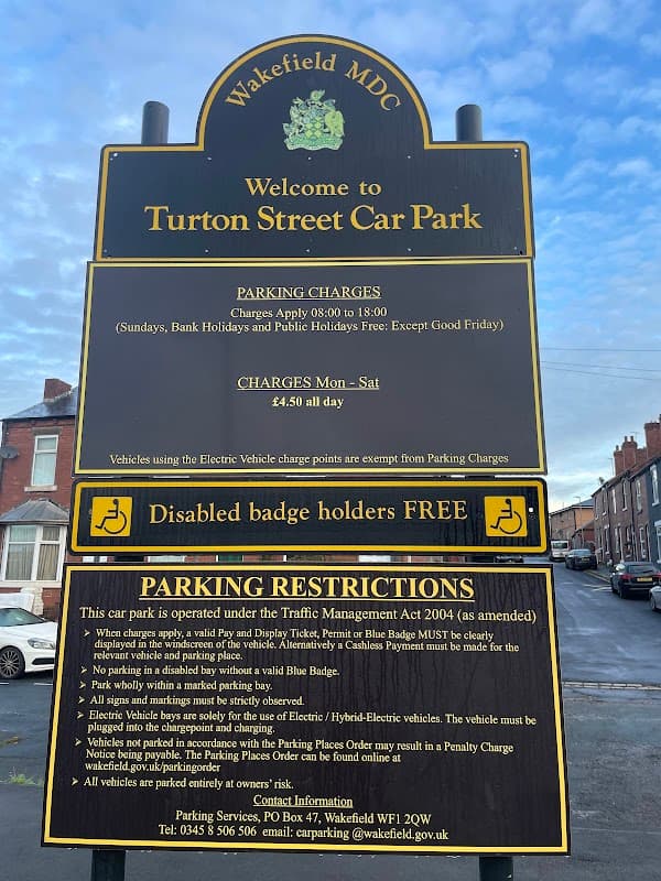 Sign for Turton Street Car Park in Wakefield, detailing parking charges, restrictions, and free access for disabled badge holders.