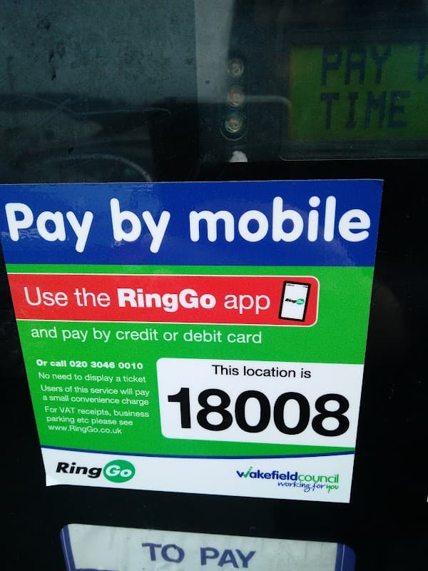 Pay by mobile sign for RingGo app, with location number 18008, at Unity House Car Park in Wakefield, Yorkshire.
