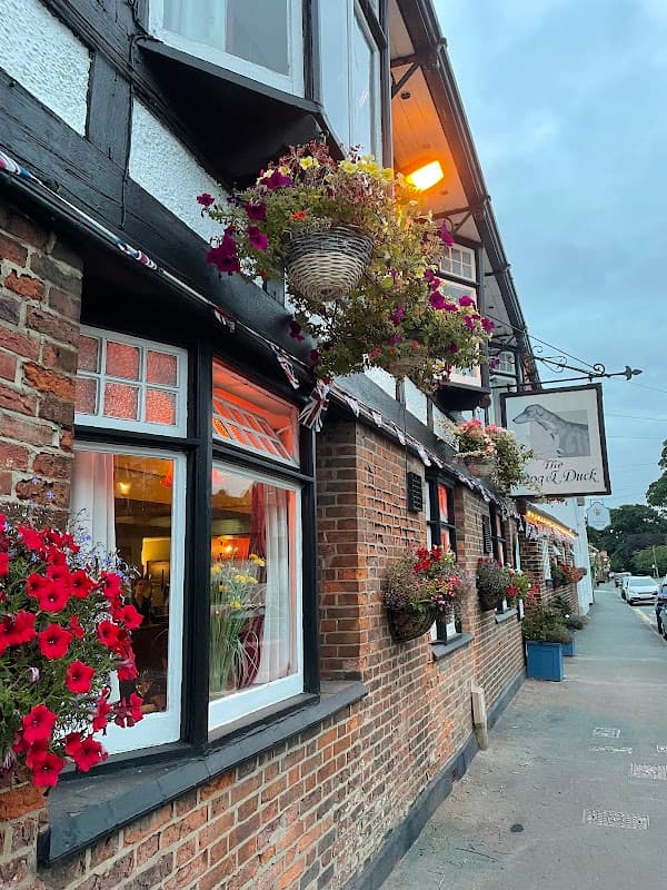 Charming pub exterior with flower baskets, warm lighting, and traditional architecture in Walkington, Yorkshire.