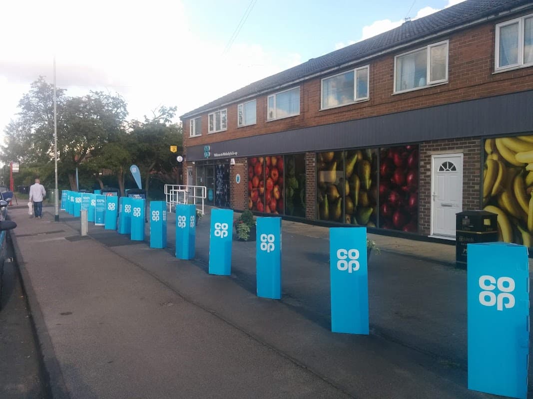 Co-op Food storefront in Wetherby with colorful fruit murals and blue signage along the pavement.