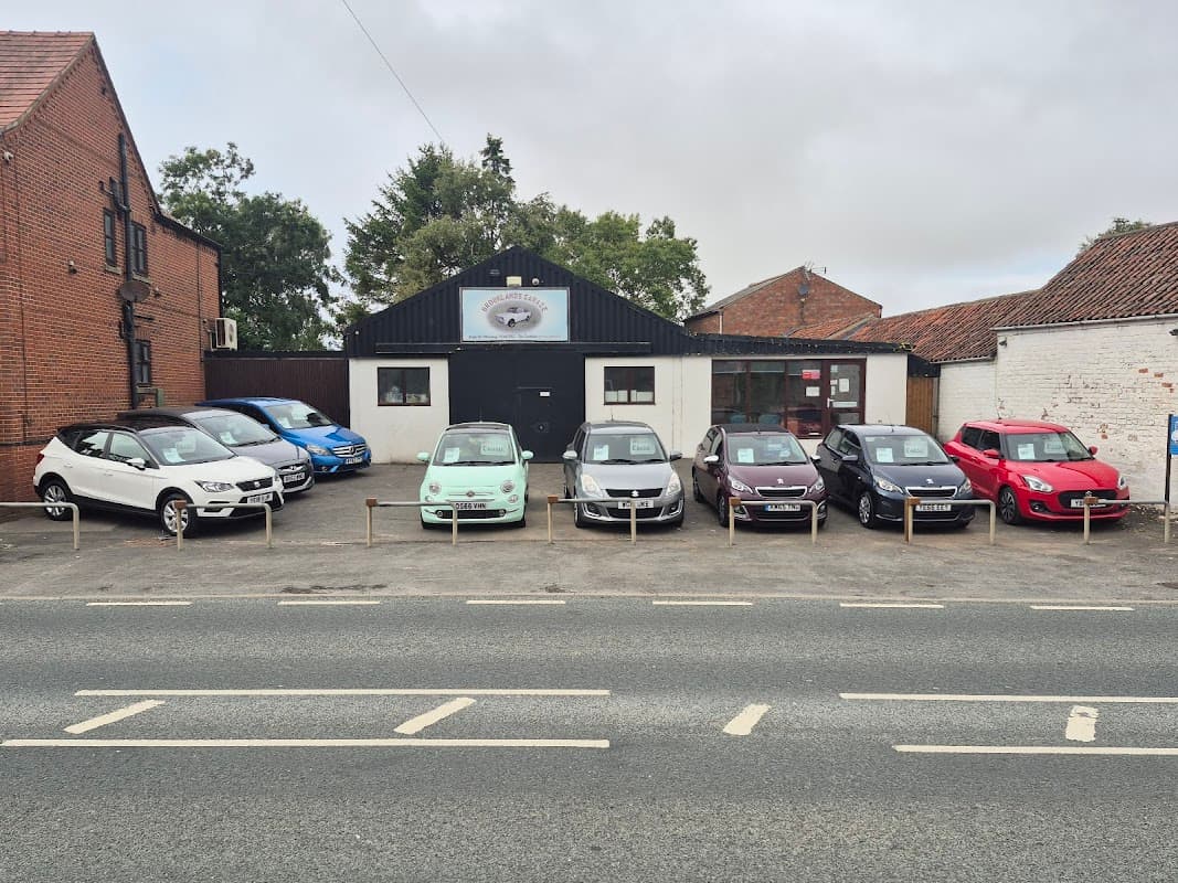 Brooklands Garage in Wetwang, Yorkshire, featuring a row of parked cars outside a brick building.