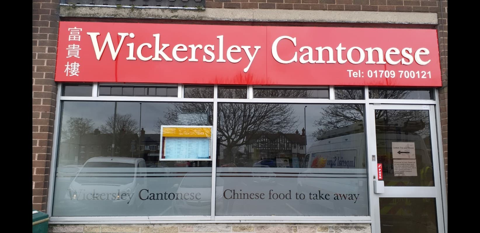 Bright red sign with "Wickersley Cantonese" and "Chinese food to take away" displayed prominently on a restaurant window.