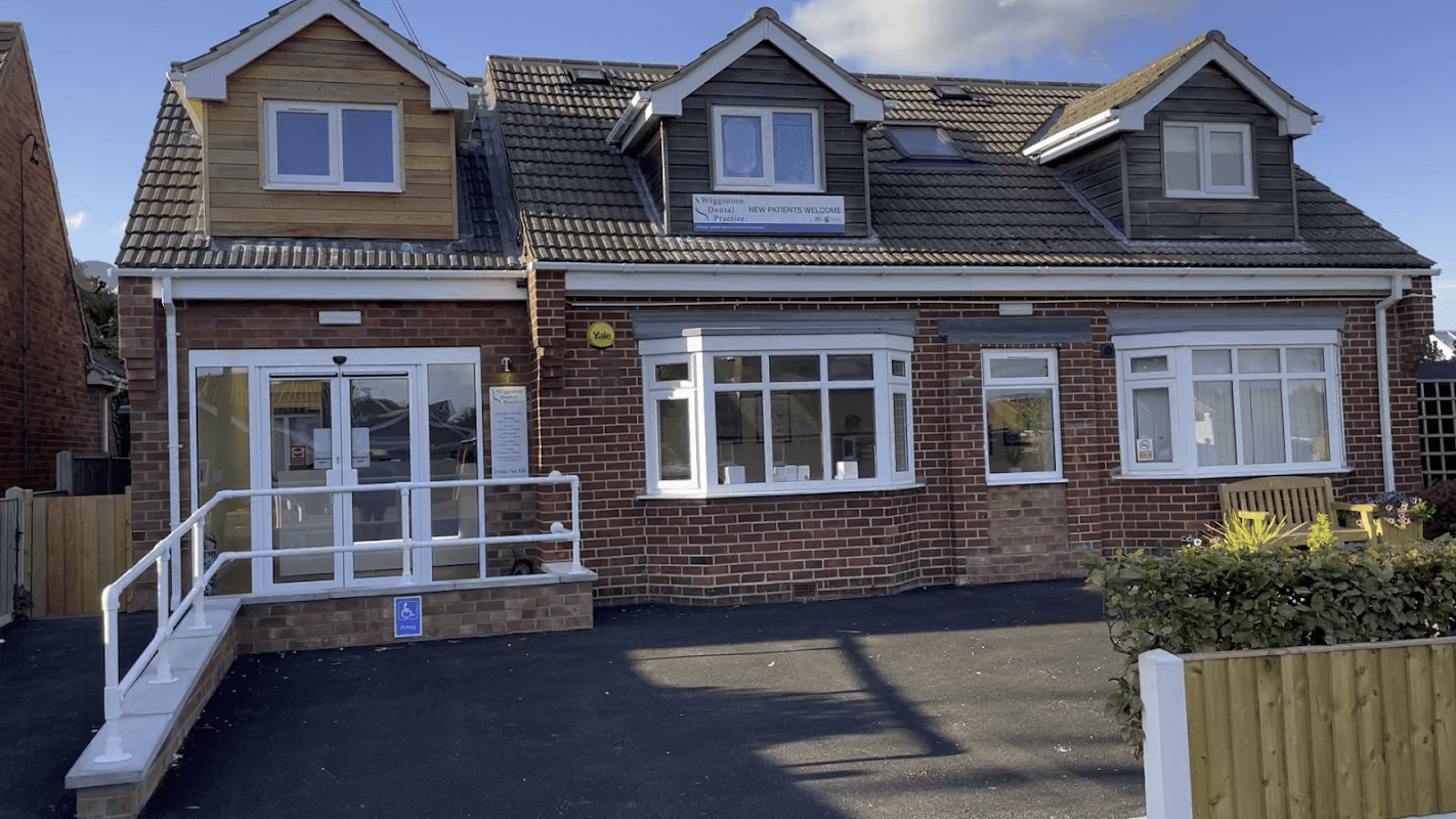 Wigginton Dental Practice features a modern brick building with a sloped roof and accessible entrance.