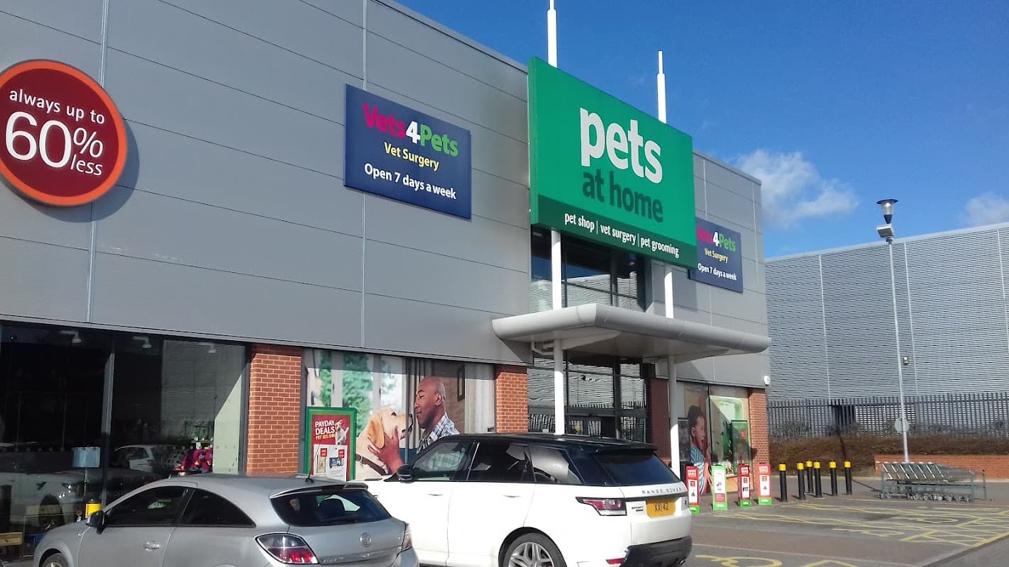 Exterior of Pets at Home store with signage, parking area, and clear blue sky in Barnsley, Yorkshire.