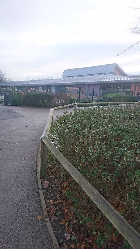 Wombwell Park Street Primary School with a modern building, pathway, and surrounding greenery in Wombwell, Yorkshire.