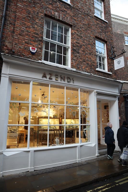 Jewellery shop Azendi with large glass windows showcasing displays, set in a brick building in York.