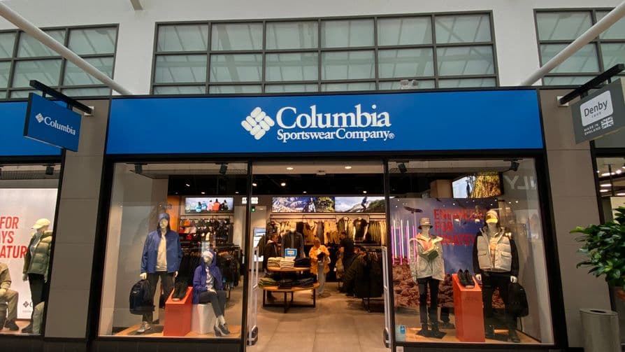 Columbia Sportswear Outlet storefront featuring outdoor apparel displays and promotional signage.