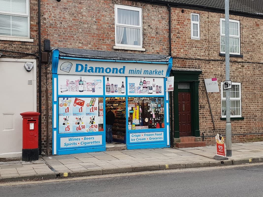 Brightly colored storefront of Diamond Mini Market with various products displayed, including drinks and groceries.