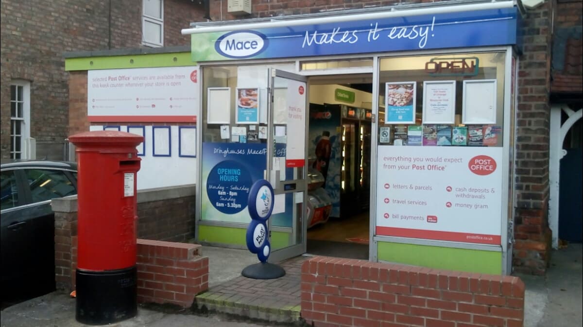 Dringhouses Post Office & Go Local with a red post box, vending machine, and signage displaying services and hours.