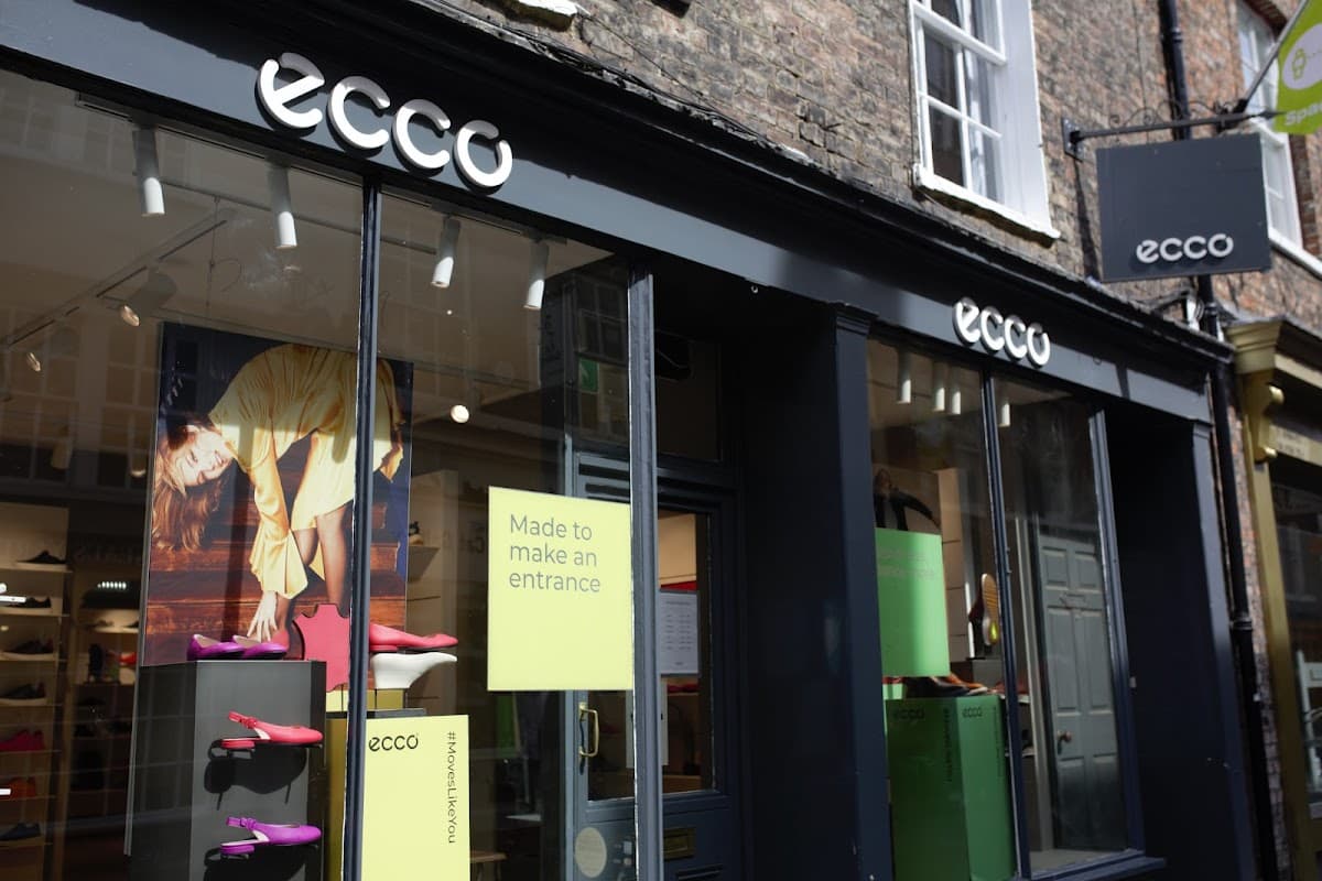 ECCO York storefront with large windows displaying colorful shoes and promotional signage.