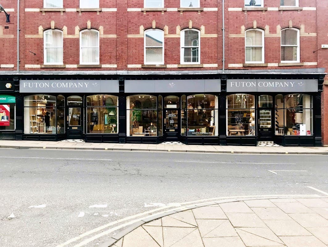 Futon Company storefront in York, featuring large windows displaying homeware and furniture against a red brick building.