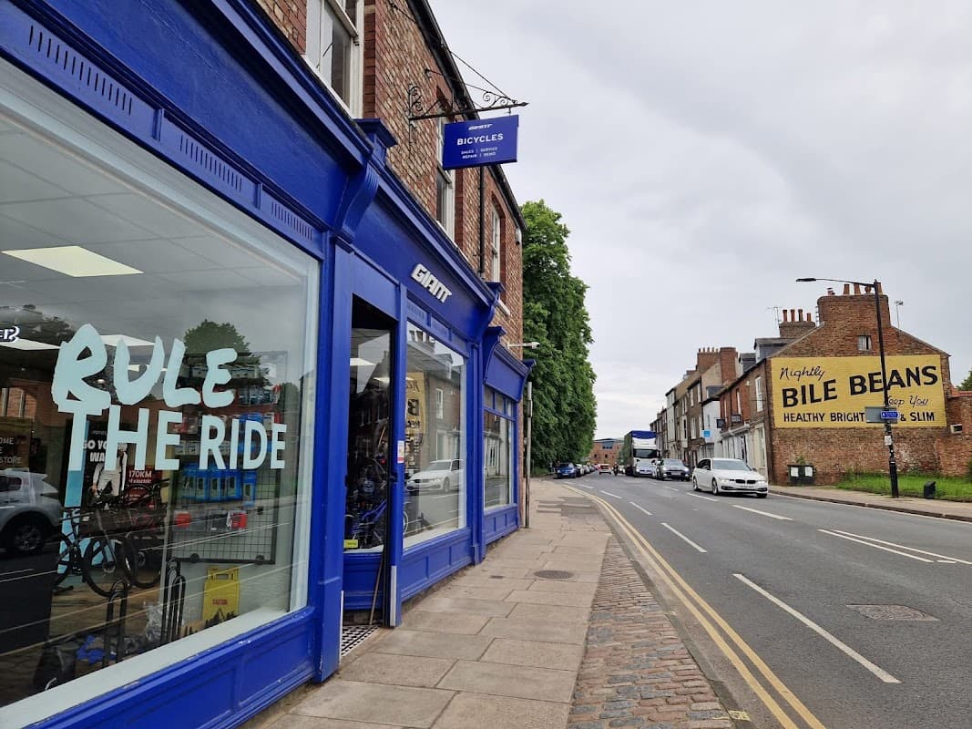 Giant Store York features a blue storefront with "Rule the Ride" signage, alongside a street view of nearby buildings.