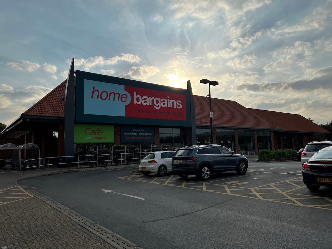 Home Bargains store exterior in York, with a red sign, parked cars, and a cloudy sky in the background.