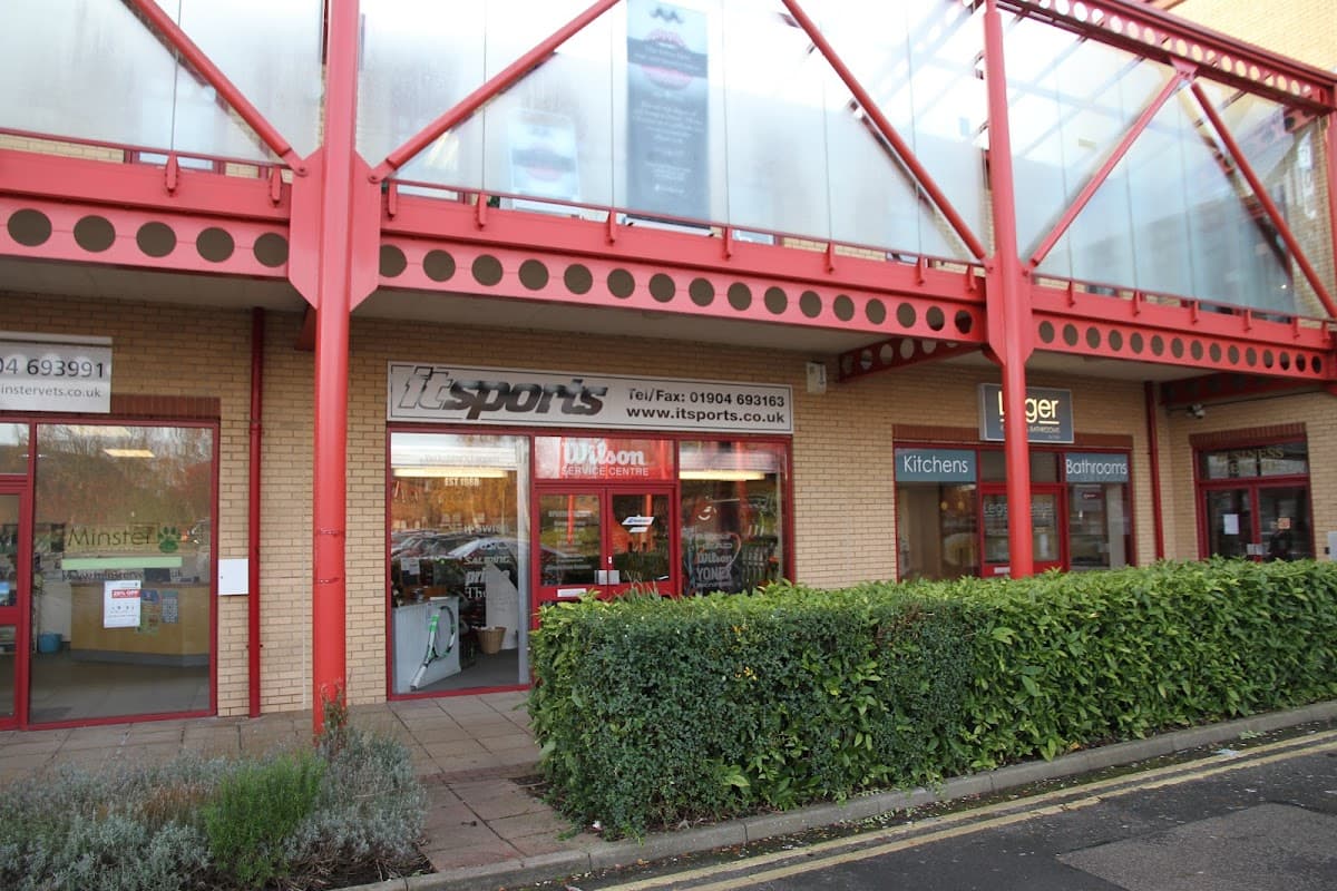 IT Sports shop front with large windows, showcasing sports equipment, located in a modern building in York, Yorkshire.