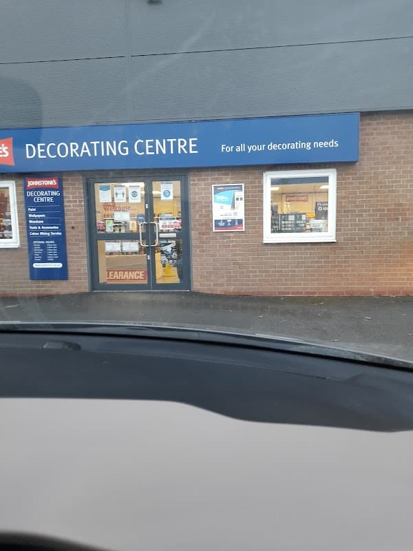 Johnstone's Decorating Centre storefront with signage, entrance, and large windows displaying products.
