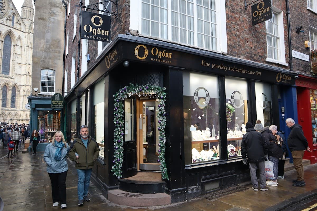 Jewellery shop Ogden of Harrogate with festive decorations, people walking by, and historic buildings in York.