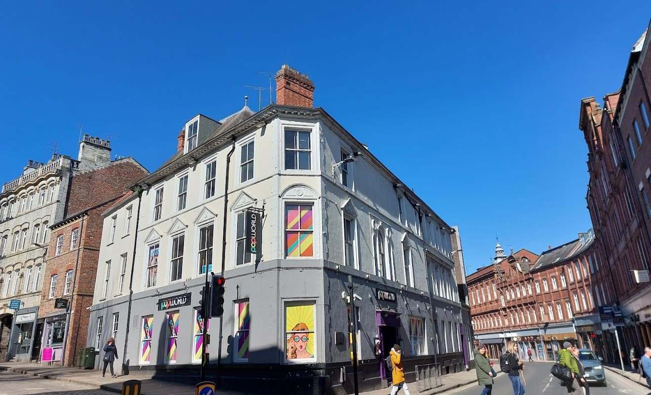 Colorful exterior of Popworld York nightclub, with vibrant window designs and a clear blue sky overhead.