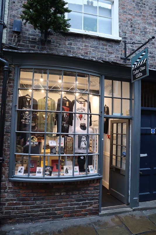 Shopfront of Take One Gifts in York, featuring various gift items displayed in a large window.